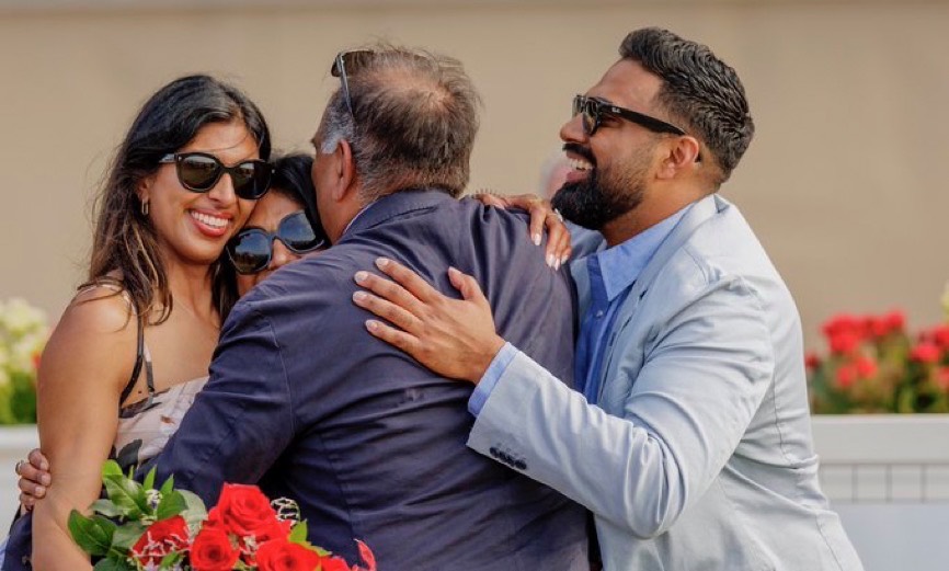 Jeffrey Sengara sharing a joyful embrace with family at the racetrack